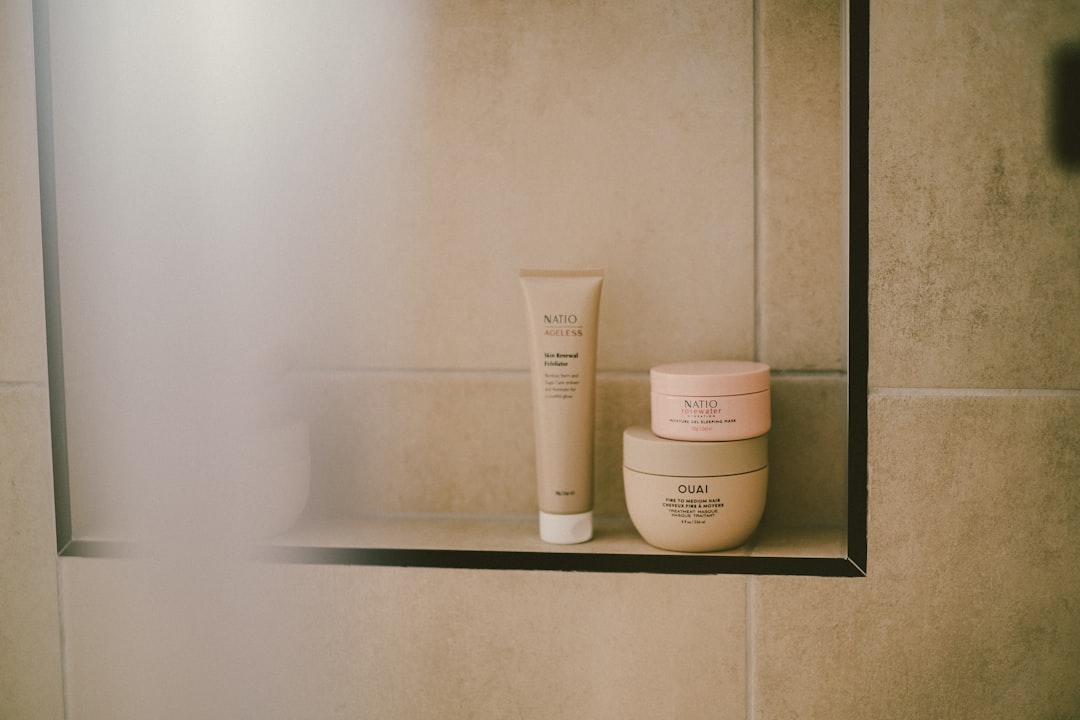 mindfulness practice — Skincare products sit on a shelf in a shower.