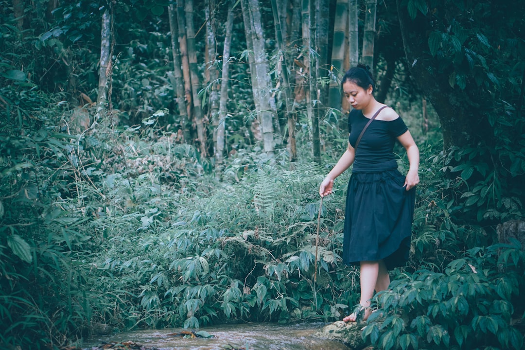 sleep mental health — Woman walking through a lush green forest